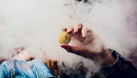 تصویر دست انسان و نگه داشتن سکه بیت کوین